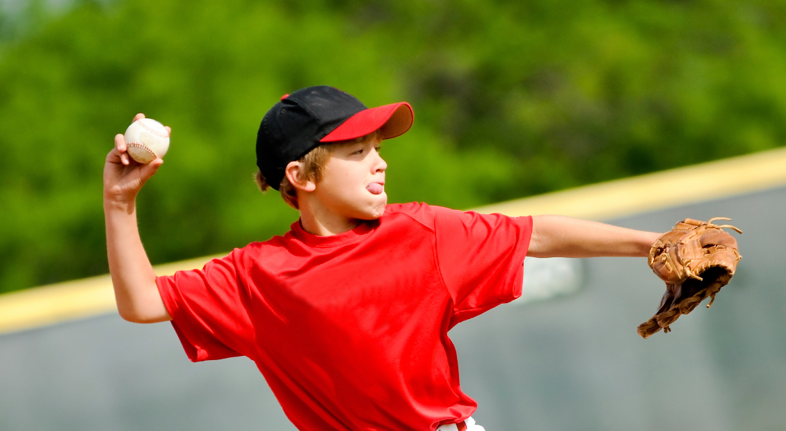 Youth baseball player throwing ball